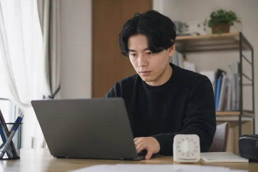 Learner practising with a timer beside the laptop